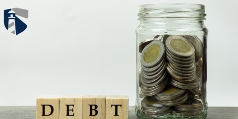 debt spelled out and jar of coins