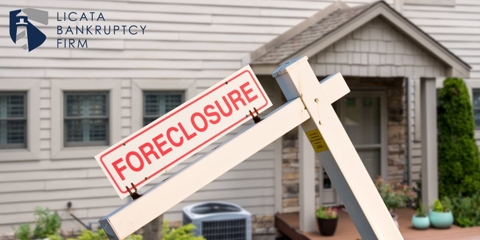 home with foreclosure sign in front