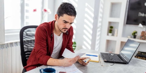 worried individual looking at a paycheck