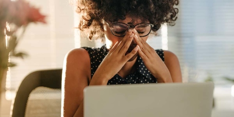Stressed woman at a word desk