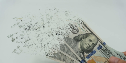 Three $100 bills fading away