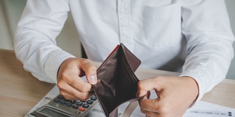 Man holding empty wallet open