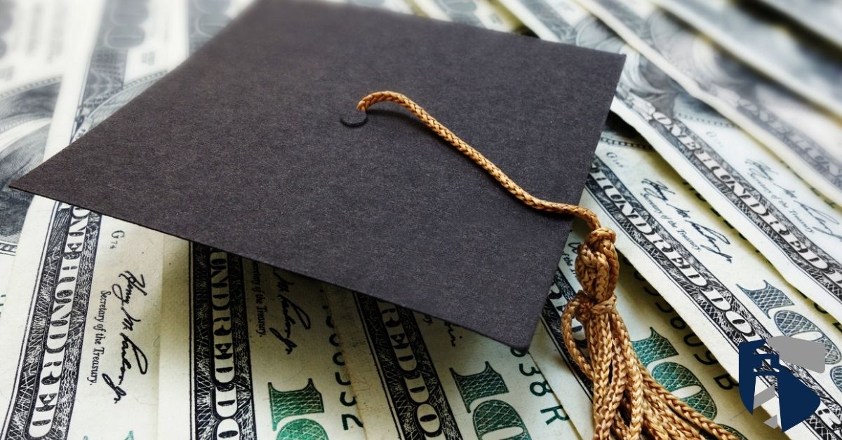 Graduation cap on top of $100 bills