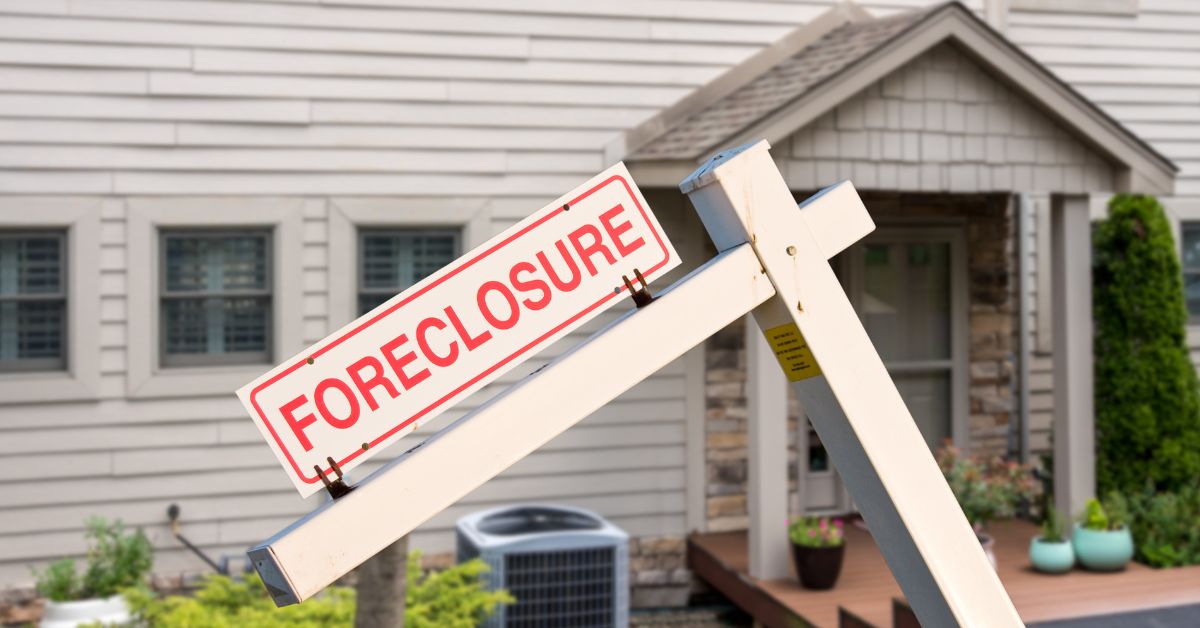 home with foreclosure sign in front