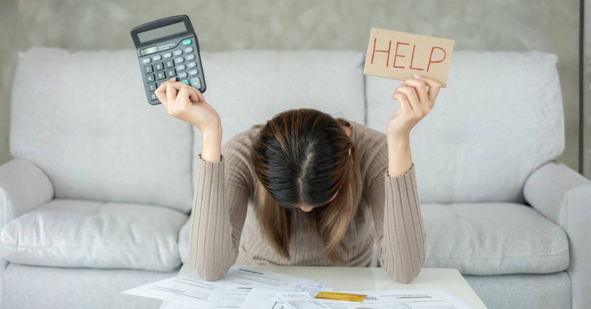 Stressed woman with large bills or invoices