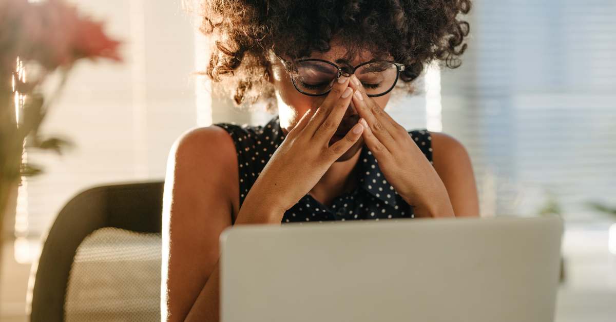 Stressed woman at a word desk